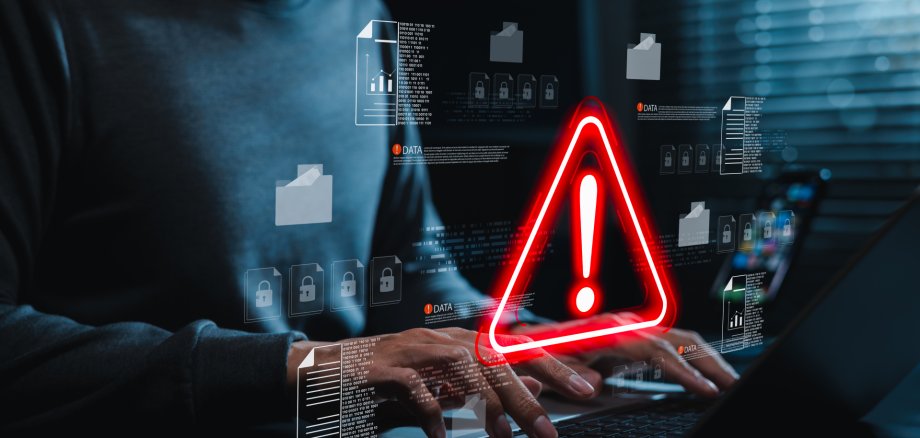 Data security warning and cyber risk alert concept. Person using laptop with digital files, lock icon, red warning symbol. data breach, document protection, threat detection, secure incident response